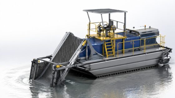 Amphibious weed harvester collecting aquatic vegetation from a lake and wetland area
